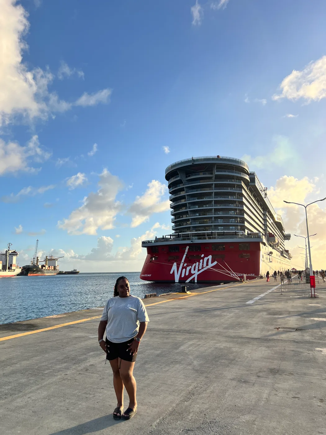 Janita on the pier in front of a Virgin Voyages cruise ship